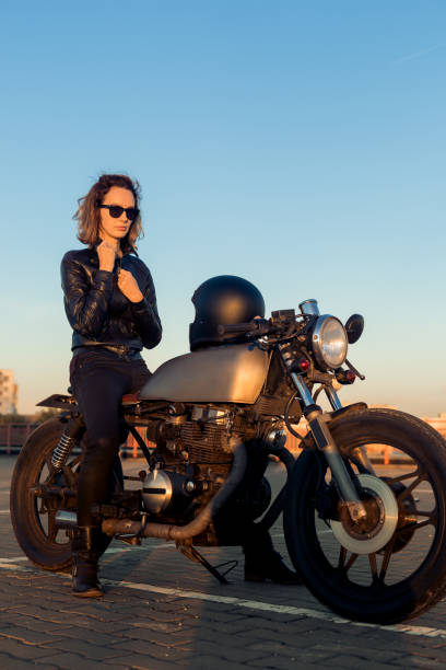 istock Biker girl on caferacer motorcycle. 1185798224