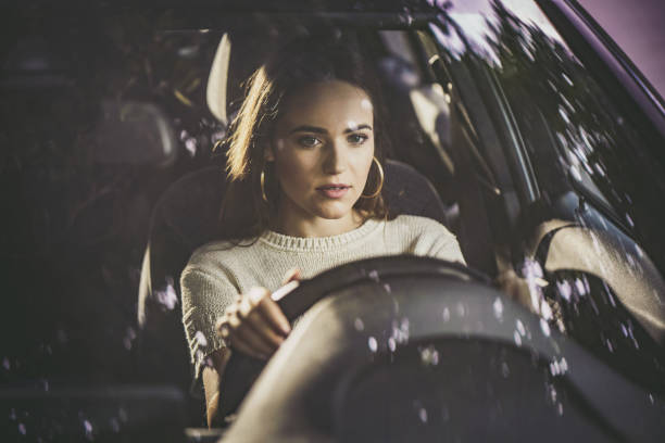 istock Beautiful woman driving a car. 1185804370