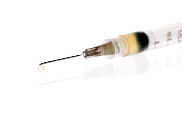 istock Medical Syringe With Drip Focus On Tip 118580531