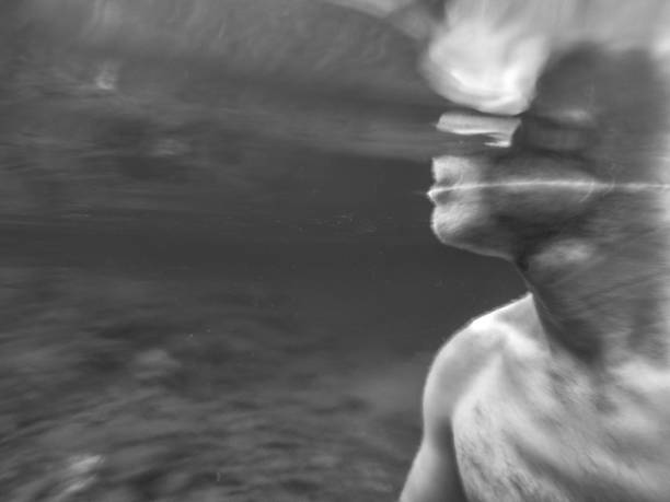 istock Part of a male face underwater in black and white 1185809802