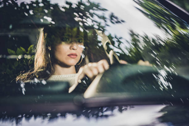 istock Young beautiful woman driving a car. 1185809910