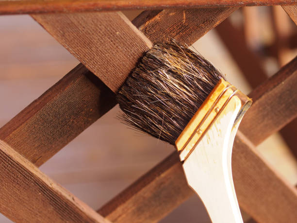 istock A fence is applied by a brush. 1185811873