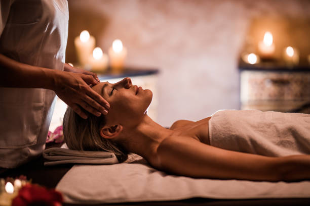 donna che si gode il massaggio alla testa durante il trattamento di bellezza nella spa. - pampering massaging indoors adult foto e immagini stock