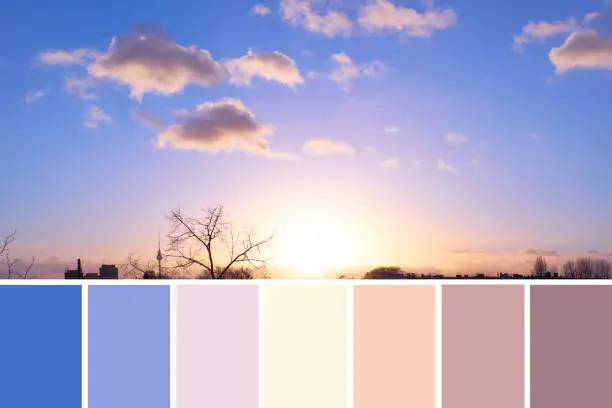 Color matching swatch palette from panoramic image of sky over Berlin on sunset with cream and purple fluffy clouds with golden yellow Sun on darkening blue sky, natural color scheme