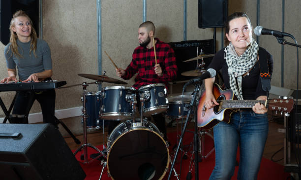 istock Cheerful guitar player and singer with band 1185817154