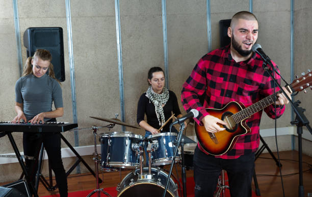istock Bearded guy soloist playing guitar in studio 1185817169
