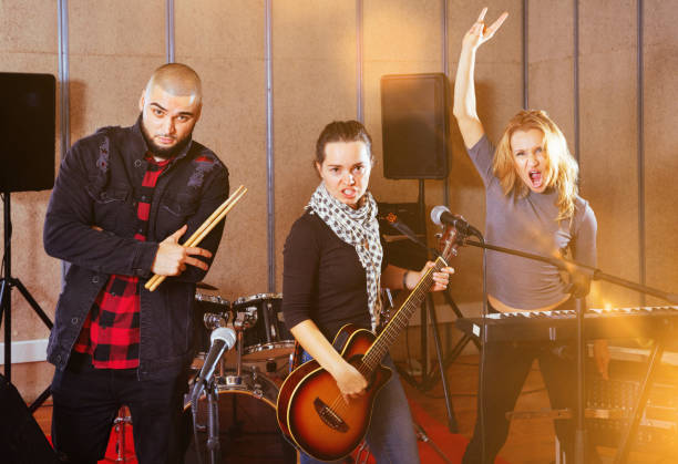 istock Three bandmates posing together with musical instruments in rehe 1185817178