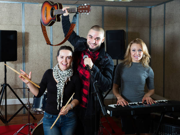 istock expressive group of rock musicians posing with instruments 1185817193