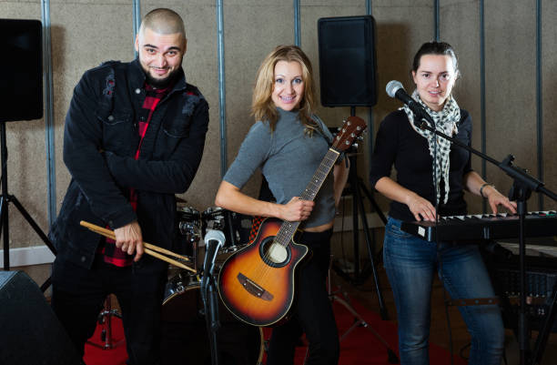 istock group of rock musicians posing with instruments 1185817208