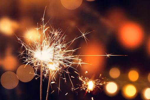 Golden sparklers in numbers digits shape set, burning bright with sparks, isolated on black background