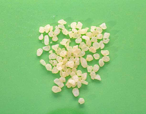 Mastic resin tears. Chios mastic on green color background, top view