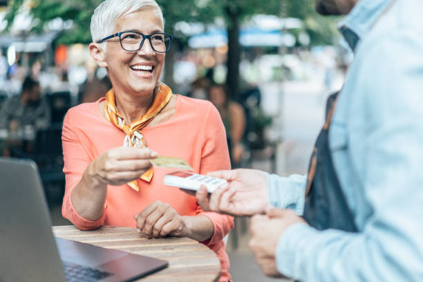 istock Mature woman paying contactless 1185828005