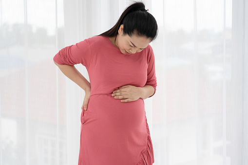 Pregnant women feel back pain and discomfort.