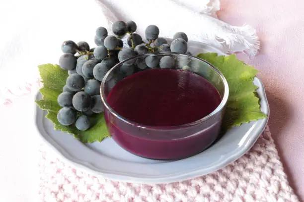 purple grape pudding with cooked must in a glass cup