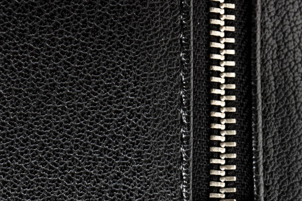 Close-up of a black briefcase with a zipper (faux leather texture). Space for copy.