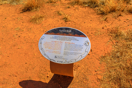 Uluru, Northern Territory, Australia - Aug 24, 2019: Kuniya walk sign in Uluru-Kata Tjuta National Park in Australian outback. This site is Uluru's creation stories: the battle between Kuniya and Liru