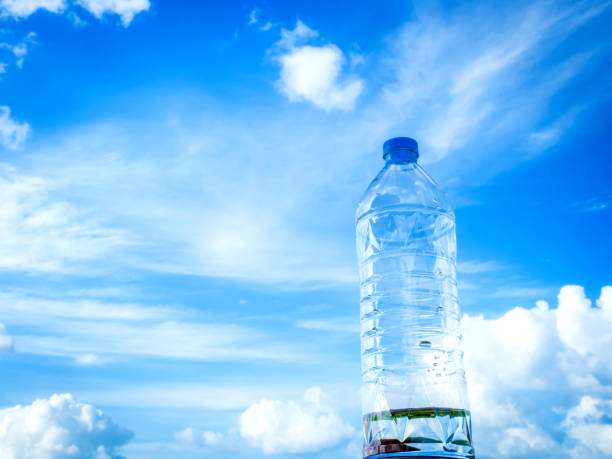 istock Bottled drinking water against blue sky and cloud 002 1185834743