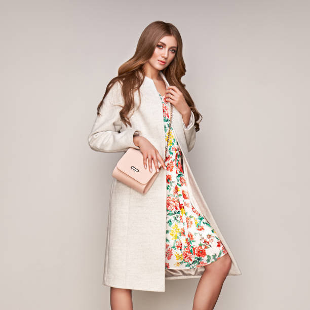 istock Young woman in white autumn coat 1185835801