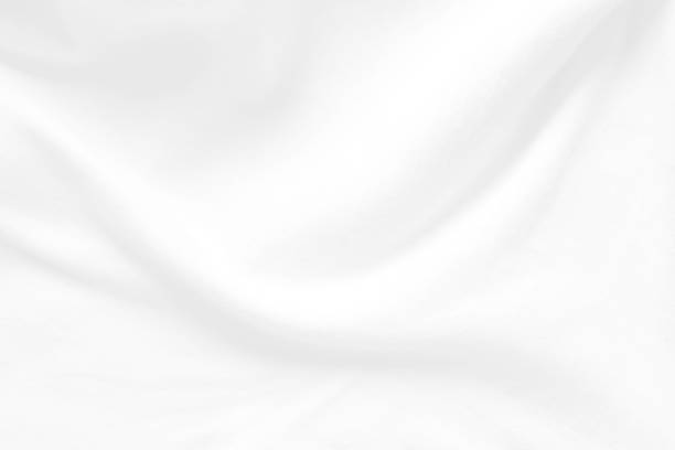 istock White cloth background abstract. Fabric is wrinkled and sofe wave. Material are used in textile assembly. 1185835811