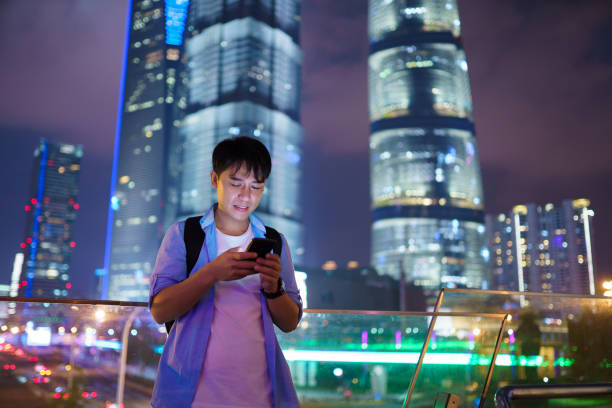 istock young asian man using smart phone at night 1185838010