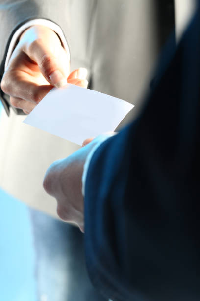 istock two business people echanging business cards 1185839917