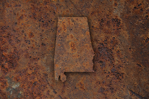 Map of Alabama on rusty metal