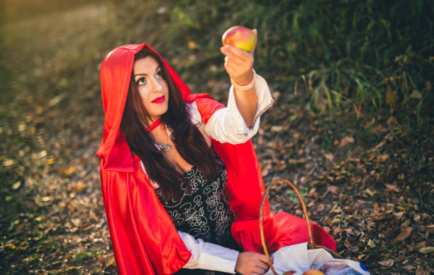 istock Little red riding hood in a forest 1185840120