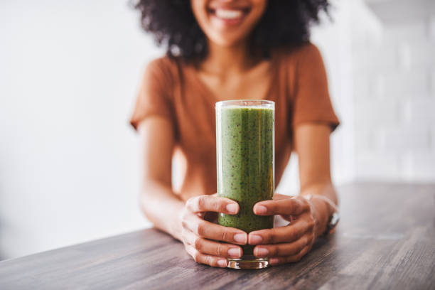 Sip on something healthy Shot of a young woman enjoying a healthy smoothie at home low carb diet photos stock pictures, royalty-free photos & images