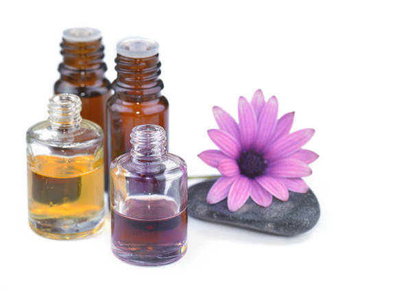 istock essential oil bottles and flower on white background 1185840409