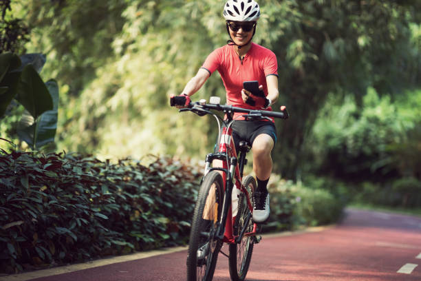 istock Riding on bike path,using smartphone while riding bike on sunny day 1185842328