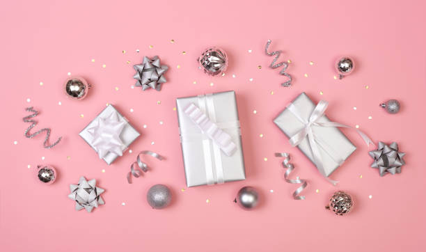 istock Christmas composition with decorations and gift box with star confetti on pink pastel background. winter, new year concept. Flat lay, top view, copy space. 1185842344
