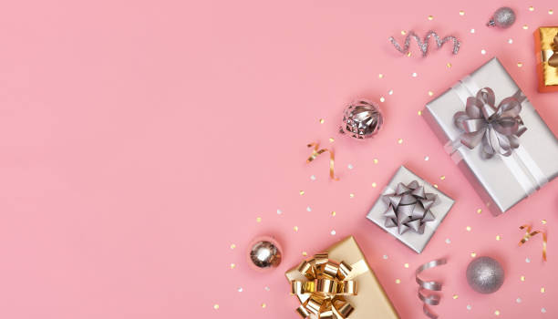 istock Christmas composition with decorations and gift box with star confetti on pink pastel background. winter, new year concept. Flat lay, top view, copy space. 1185842406