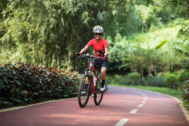 istock Riding on bike path,using smartphone while riding bike on sunny day 1185842439