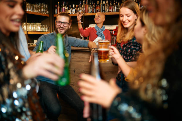 istock Waitress wiping glas while people having fun at pub. 1185846180