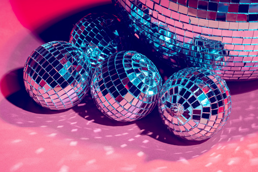 Mirror disco balls over pink background. Party, nightlife concept