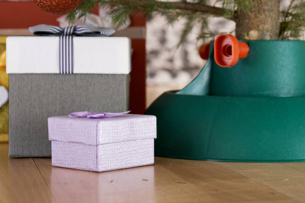 istock Gift boxes standing near a plastic Christmas tree support at home in New Year eve 1185846788