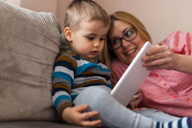 istock Mother and son with tablet at home 1185847792