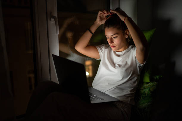 istock Young woman using laptop at home 1185847885