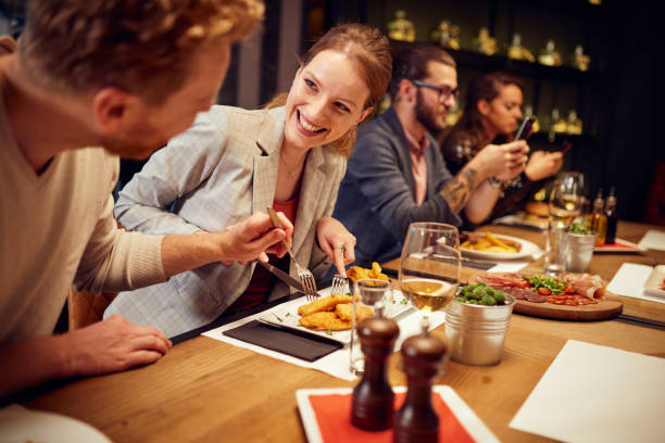 istock Couple sharing food in restaurant. 1185849578