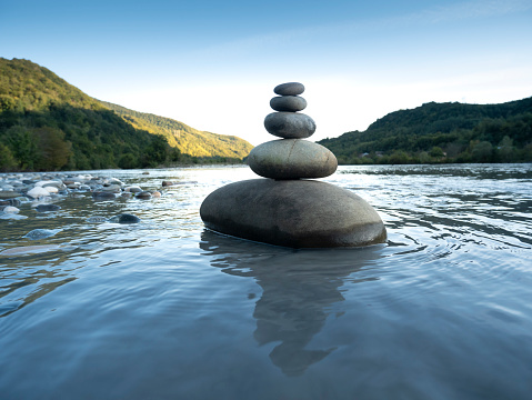 Rocks stack on the coast of Mountain River, concept of balance and harmony.