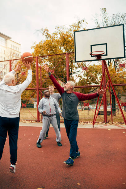 istock Senior Friends Playing Basketball 1185850504