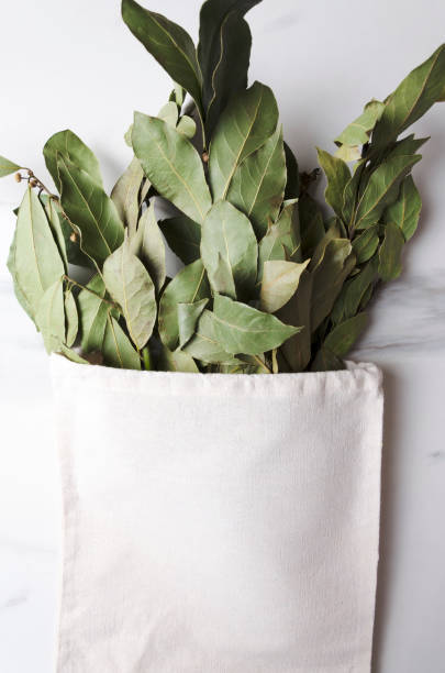 istock Vertical shot. Cloth bag and dried bay leaves on the white table 1185850529
