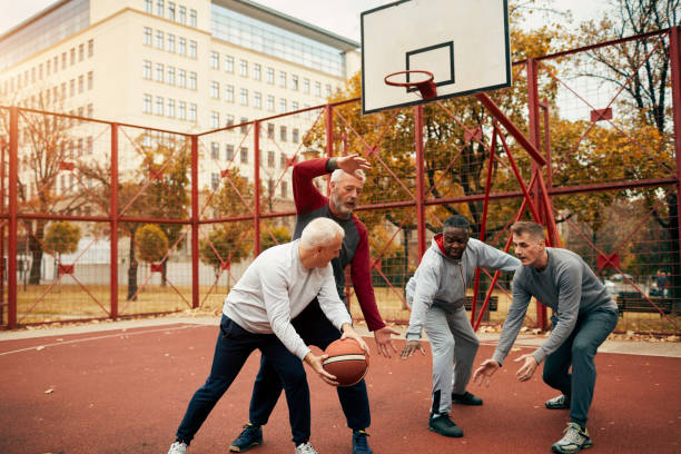 istock Senior Friends Playing Basketball 1185850536