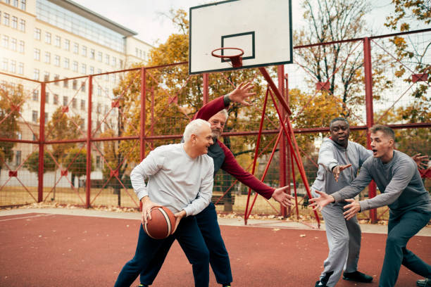 istock Senior Friends Playing Basketball 1185850653