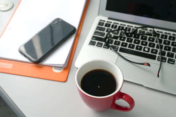 istock Office table with laptop phone files and a cup of coffee 1185850988