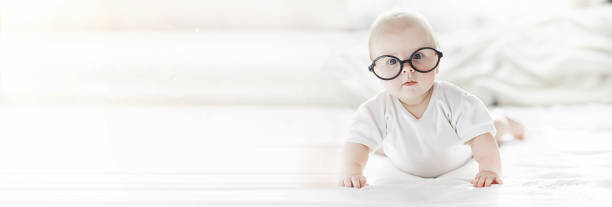 istock A newborn baby is lying on a soft bed in glasses. 1185851423