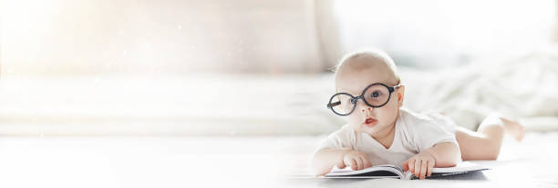 istock A newborn baby is lying on a soft bed in glasses. 1185851430