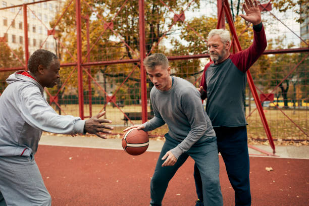 istock Senior Friends Playing Basketball 1185851441