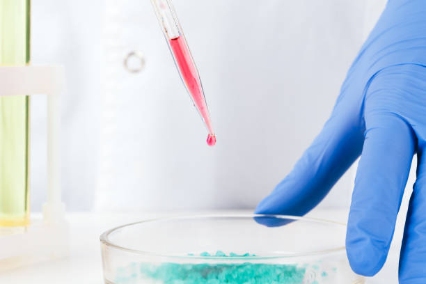istock Chemist hands holding test tubes with liquids and doing experiments 1185851673