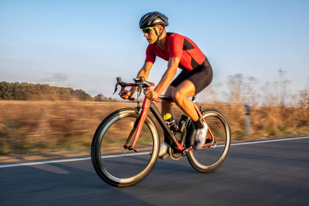 istock Athlete man riding bicycle on the road 1185852826